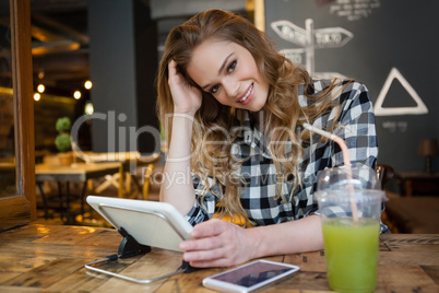Portrait of smiling woman sitting at table