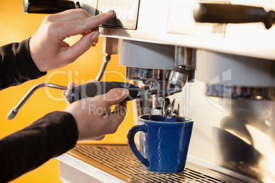 Cropped image of woman making coffee