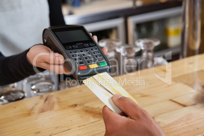 Cropped image of person making payment