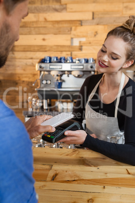 Customer making payment on credit card reader machine