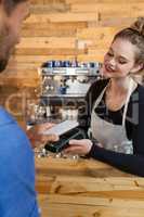 Customer making payment on credit card reader machine