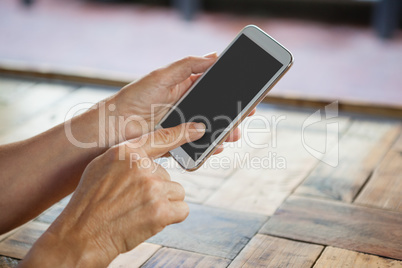 Cropped image of senior woman holding smart phone