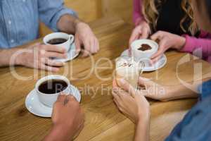 Friends having coffee at table