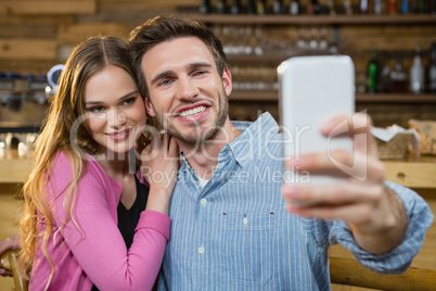 Young couple taking selfie on mobile phone