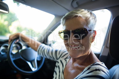 Portrait of senior woman driving car