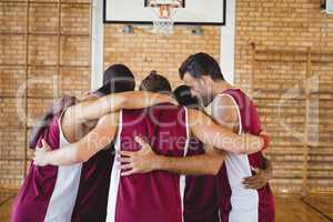 Basketball players forming a huddle