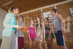 Female coach mentoring high school kids