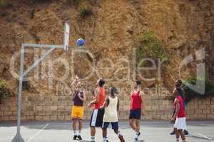 Basketball players playing basketball in the court