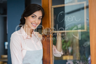 Portrait of waitress standing at the entrance