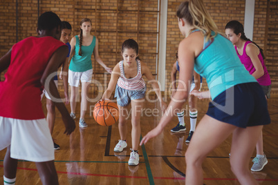 High school kids playing basketball in the court