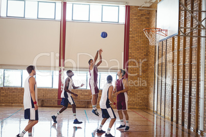 Basketball players playing in the court