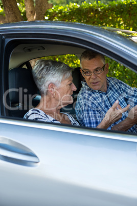 Senior couple talking in car