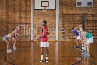 High school boy about to take a penalty shot while playing basketball in the court