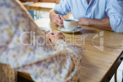 Mid section of senior couple having coffee