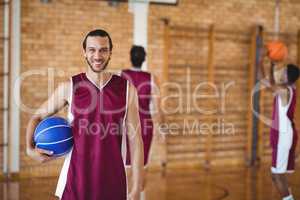 Smiling basketball player holding a basketball