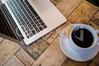 Close up of laptop and coffee cup on table