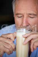 Close up of senior man drinking cold coffee