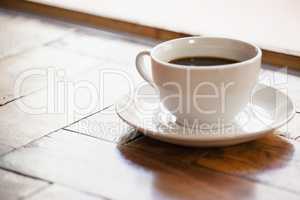 Close up of black coffee in cup on wooden table