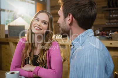 Young couple interacting while having coffee
