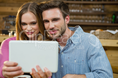 Young couple using digital tablet