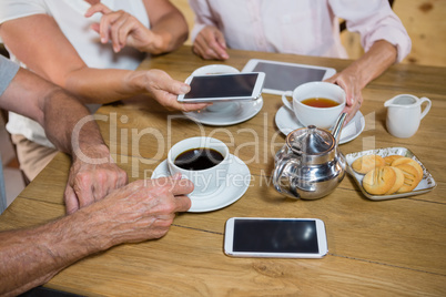 Group of senior friends having coffee