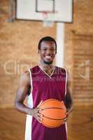 Smiling basketball player holding a basketball