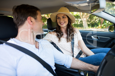 Couple looking at each other while sitting car