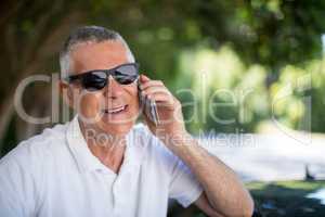 Happy senior man talking on phone