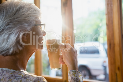 Thoughtful senior woman having coffee