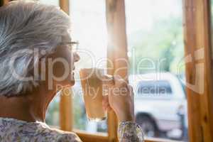 Thoughtful senior woman having coffee