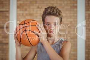 Determined boy holding a basketball