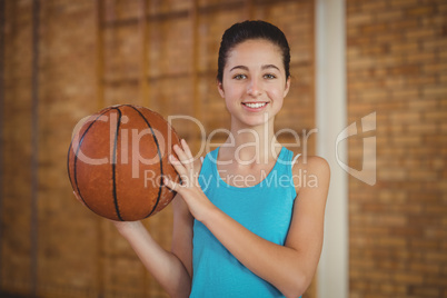 Smiling girl holding a basketball