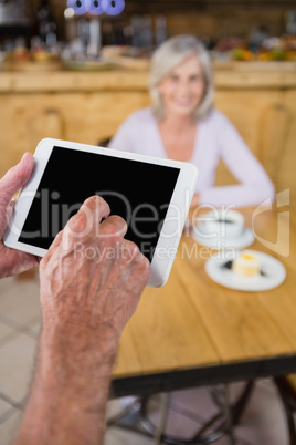 Hands of waiter using digital tablet