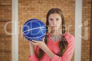 Determined girl holding a basket ball