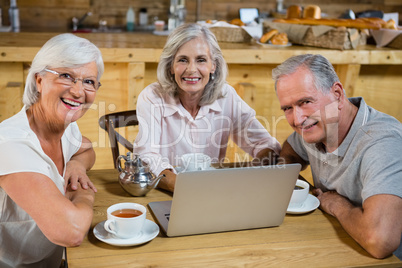 Group of senior friends using laptop