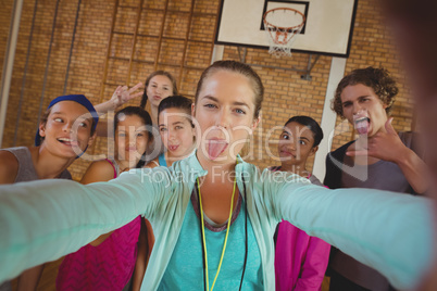 Female coach and high school kids taking a selfie