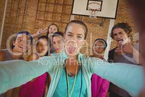 Female coach and high school kids taking a selfie