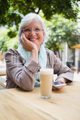 Portrait of senior woman holding mobile phone