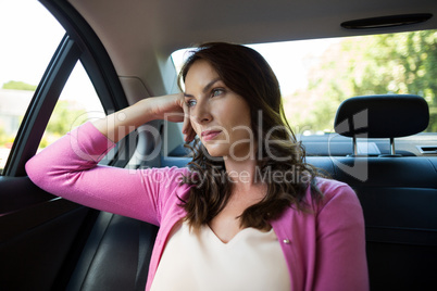 Thoughtful woman traveling in car