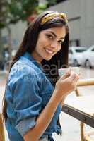 Portrait of beautiful smiling woman drinking coffee
