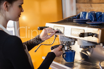 Owner making coffee at cafe shop