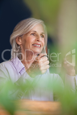 Smiling senior woman holding coffee mug