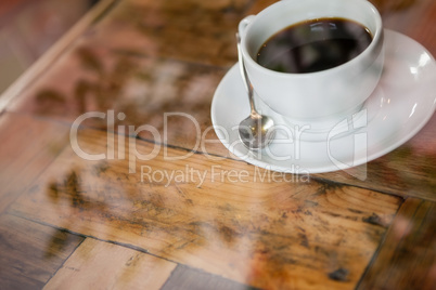 High angle view of black coffee on wooden table