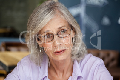 Worried senior woman looking away