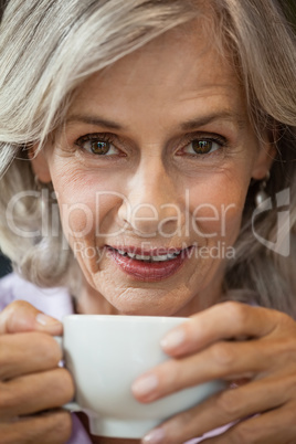 Portrait of senior woman with coffee cup