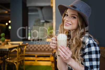 Portrait of young woman drinking cold coffee