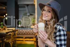 Portrait of young woman drinking cold coffee