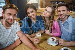 Portrait of happy friends having coffee
