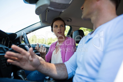 Young couple talking in car