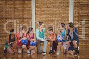 Female coach mentoring high school kids